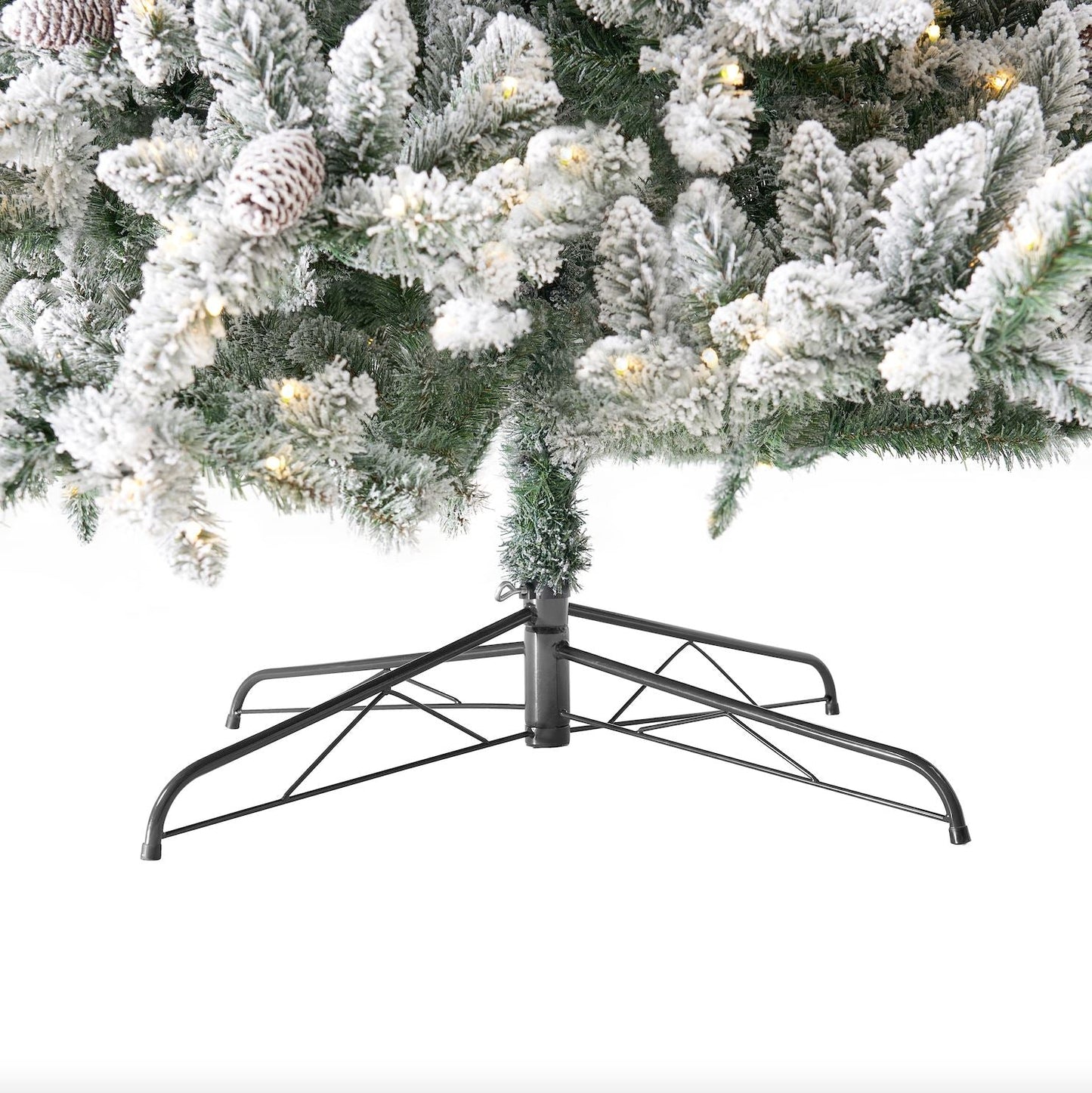 The 10’ Flocked Livingston Fir Artificial Christmas Tree with a sturdy metal stand, ready for holiday celebrations.