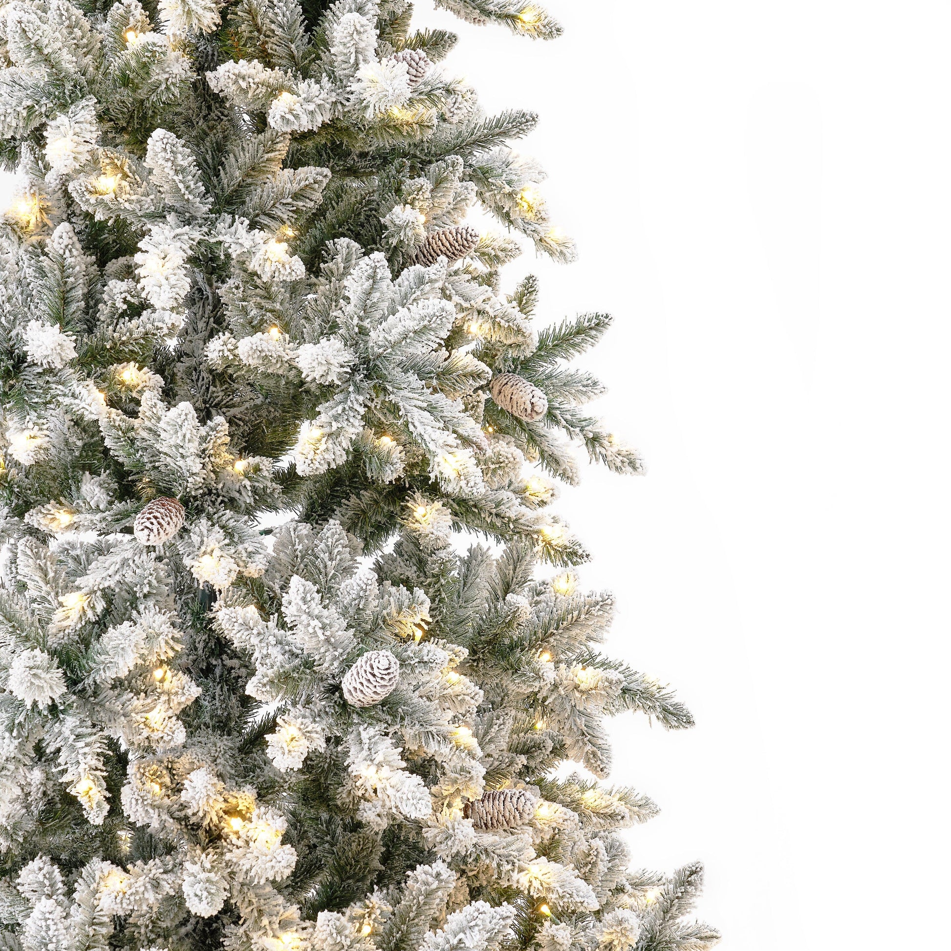 Full view of the 10’ Flocked Livingston Fir Artificial Christmas Tree decorated for Christmas with ornaments.